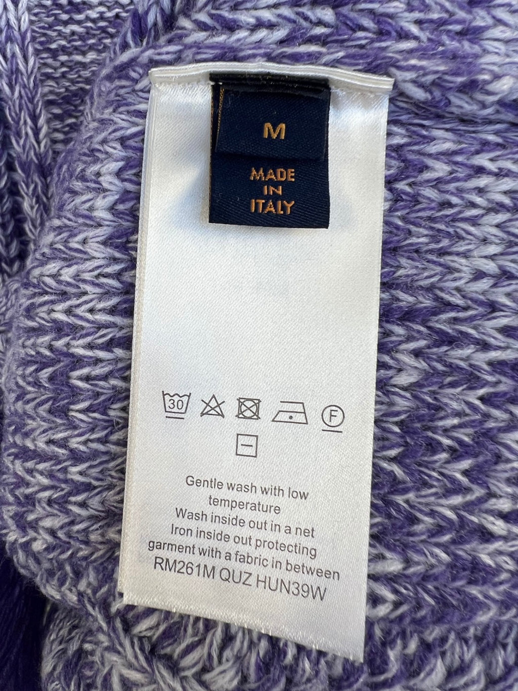 Louis Vuitton knit sweater care label on purple-and-blue marled knit