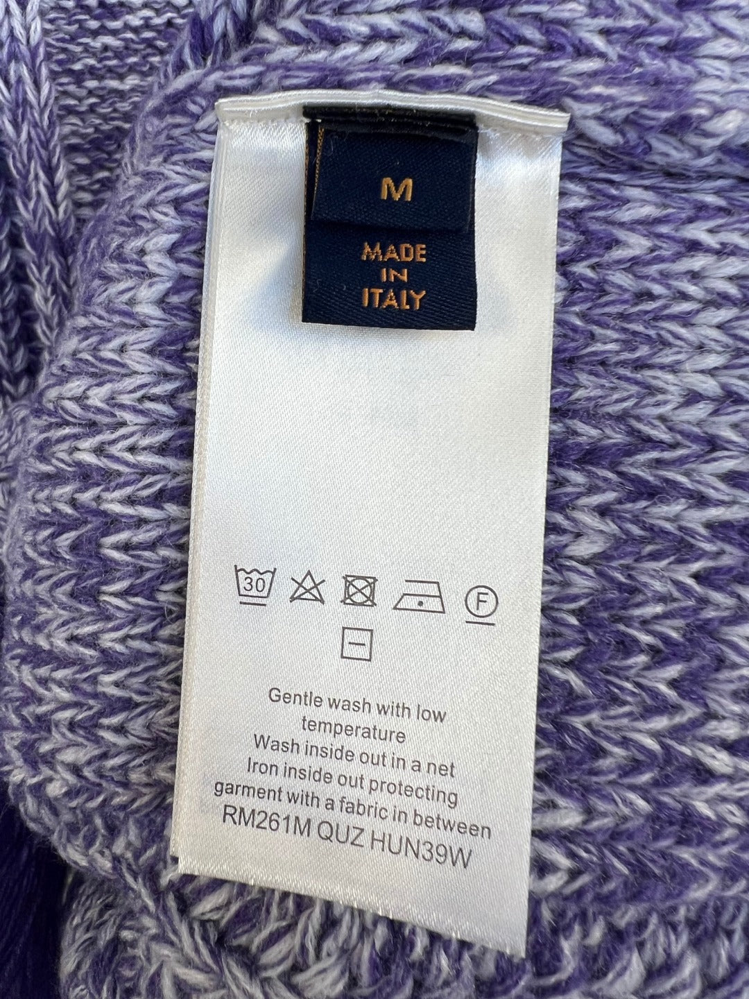 Louis Vuitton knit sweater care label on purple-and-blue marled knit