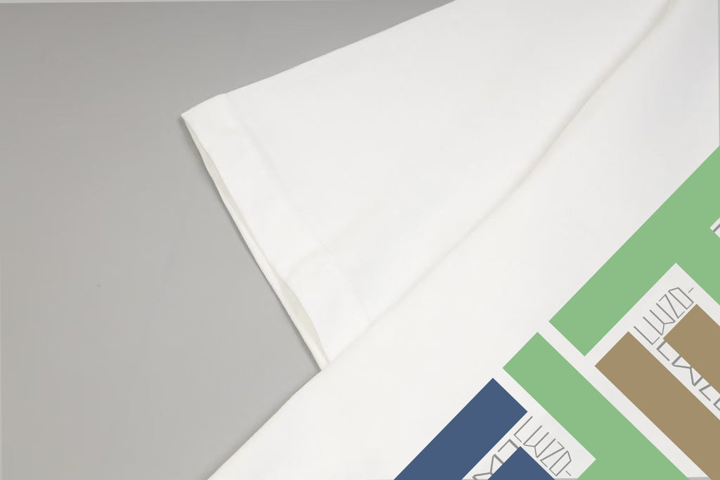 White T-shirt sleeve and side seam detail with partial multicolor print