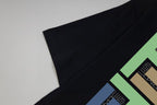 Black T-shirt sleeve and hem with multicolor geometric graphic detail