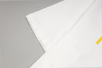 White short-sleeve T-shirt sleeve and folded hem detail