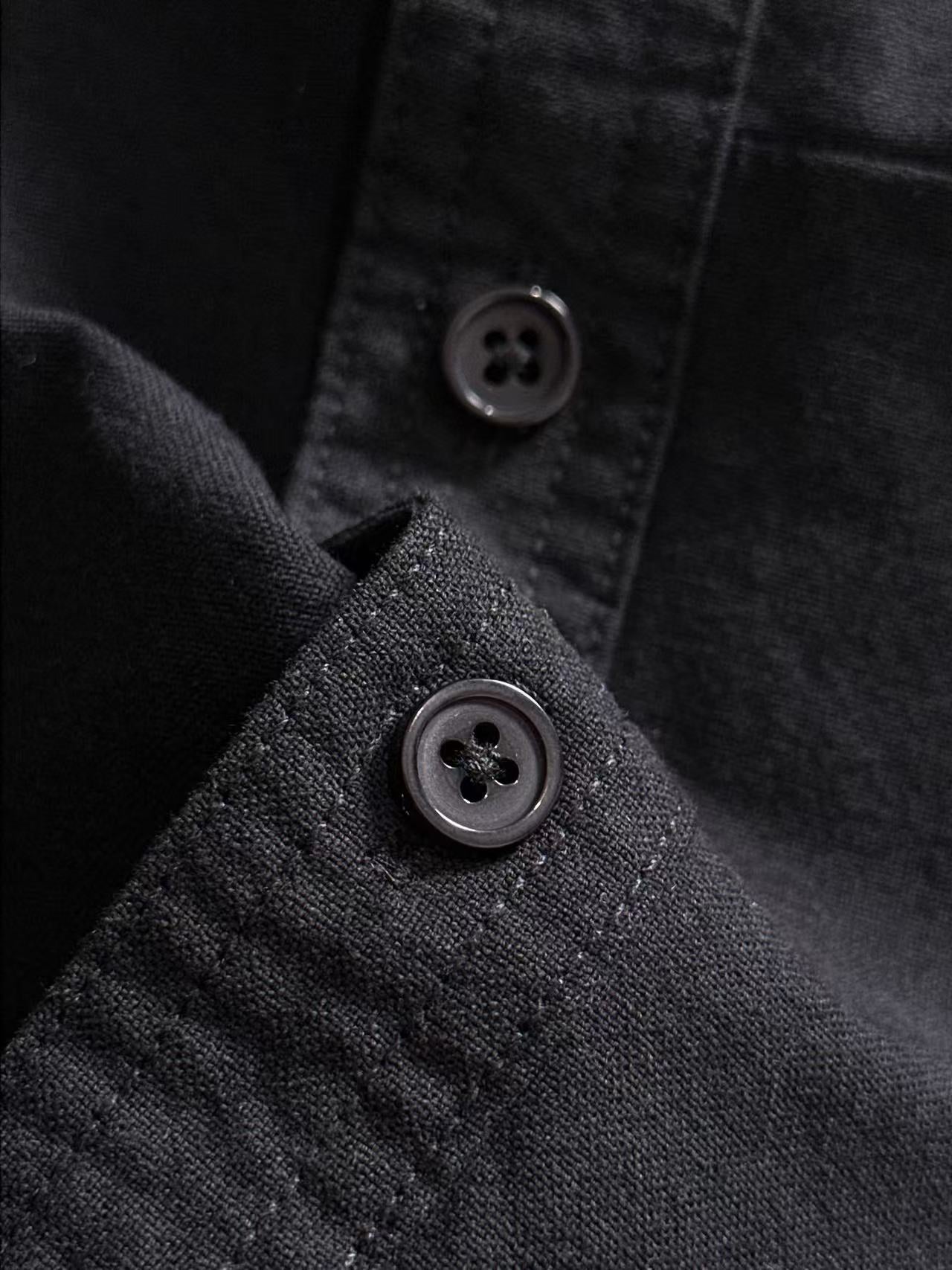 Dior long-sleeve shirt button close-up with black fabric texture