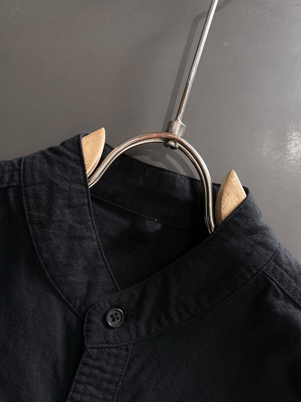 Dior long-sleeve shirt collar close-up with black buttons and neckline seam