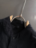 Dior long-sleeve shirt collar close-up with black buttons and neckline seam