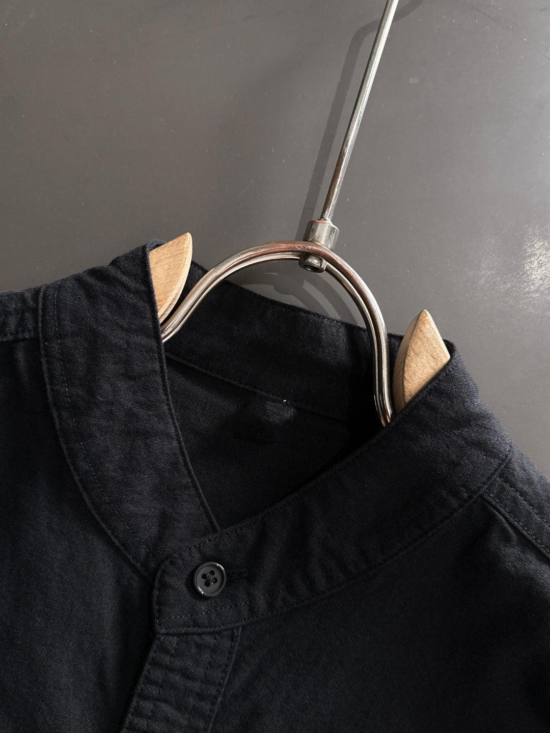 Dior long-sleeve shirt collar close-up with black buttons and neckline seam