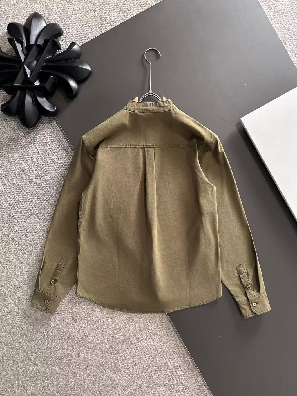 Long-sleeve shirt back view with buttoned cuffs, olive-brown.