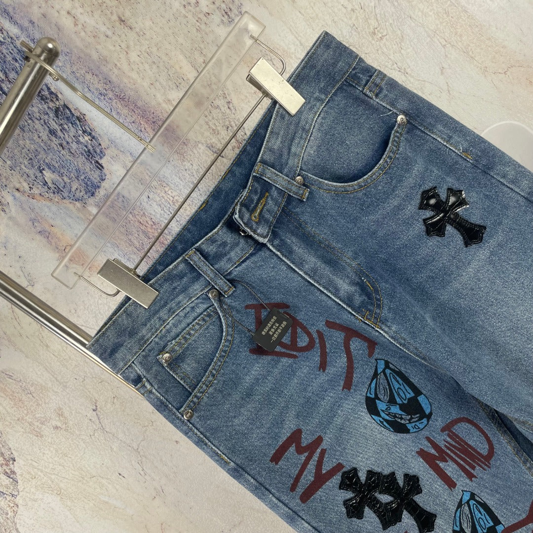 Light blue denim pants with curved waistband and multicolor front graphic print