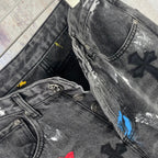 Dark denim pants close-up of waistband, pocket, and cross patches