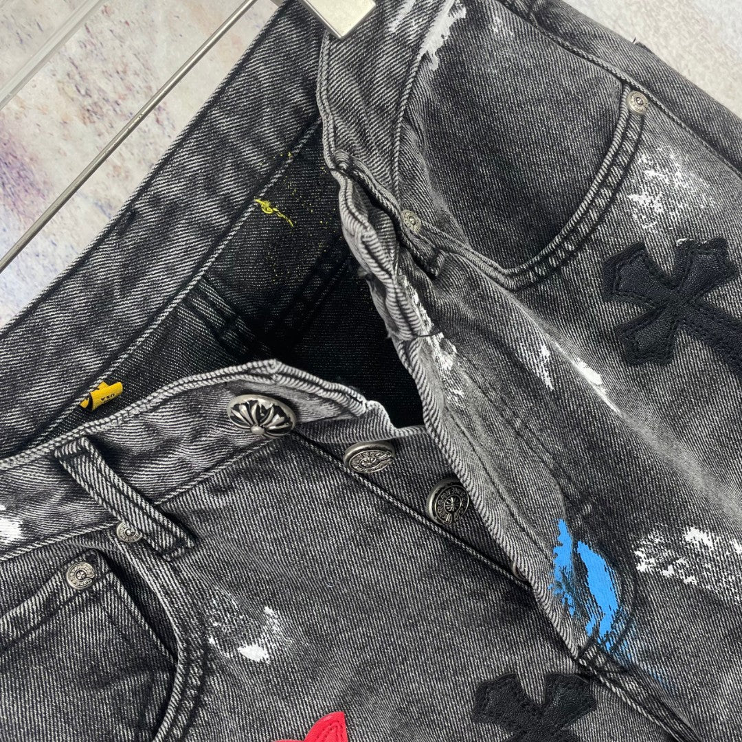 Dark denim pants close-up of waistband, pocket, and cross patches