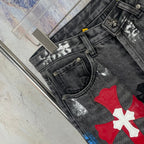 Dark denim pants close-up of front pocket and red/white cross patch
