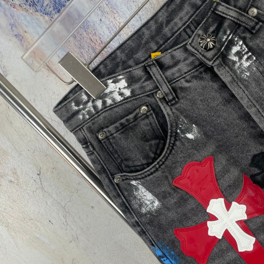 Dark denim pants close-up of front pocket and red/white cross patch