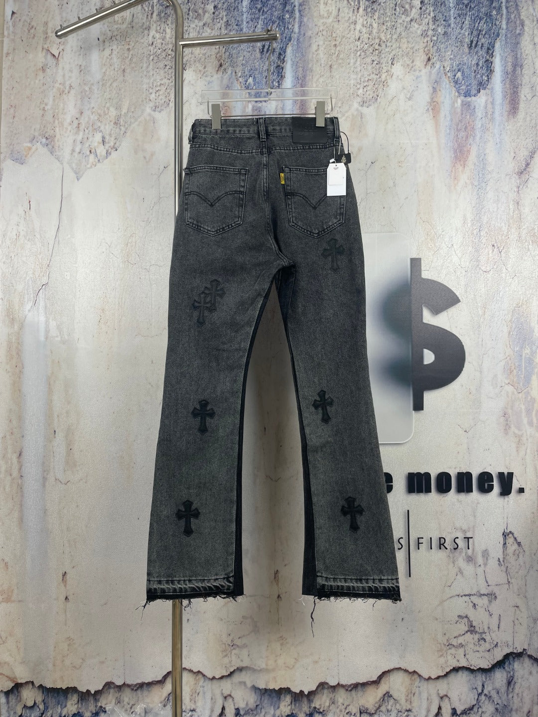 Dark gray denim pants with embroidered cross pattern, back view, straight leg