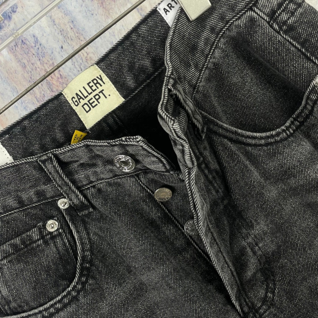 Dark gray denim pants close-up of pocket and waistband hardware