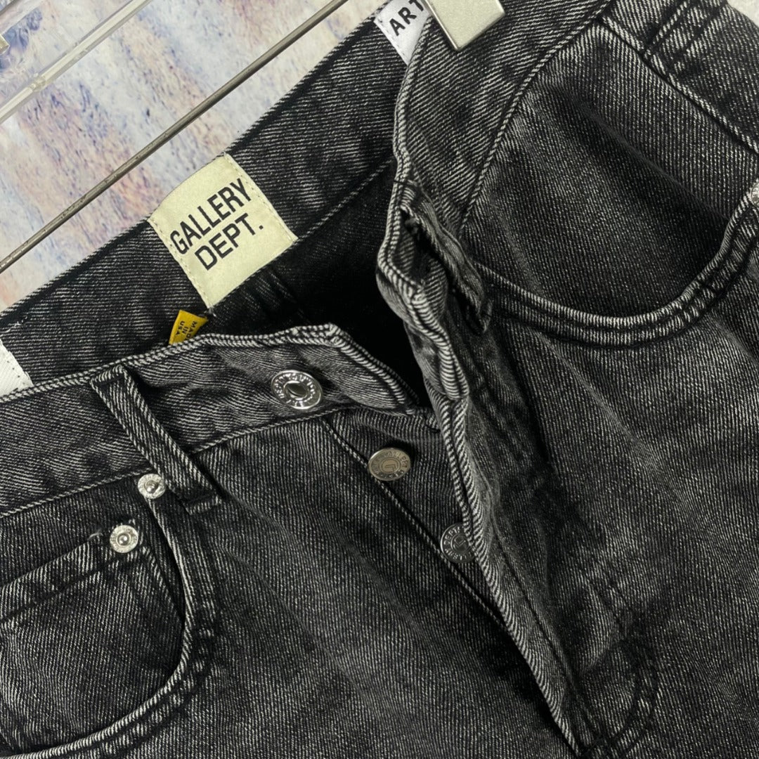 Dark gray denim pants close-up of pocket and waistband hardware