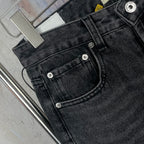 Dark gray denim pants close-up of back pockets and button stitching