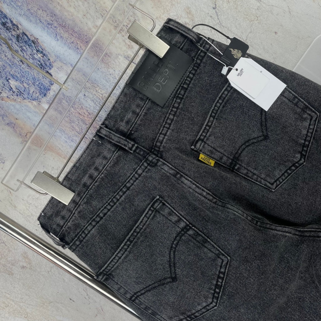 Dark gray denim pants side view with front pockets and belt loops
