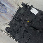 Dark gray denim pants side view with front pockets and belt loops