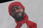 Stussy T-shirt print close-up with red-hat portrait graphic