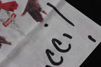 Stussy T-shirt print close-up showing black 'Gucci' lettering and hands