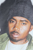 Graphic T-shirt close-up: face portrait in dark beanie with Nasty Nas text