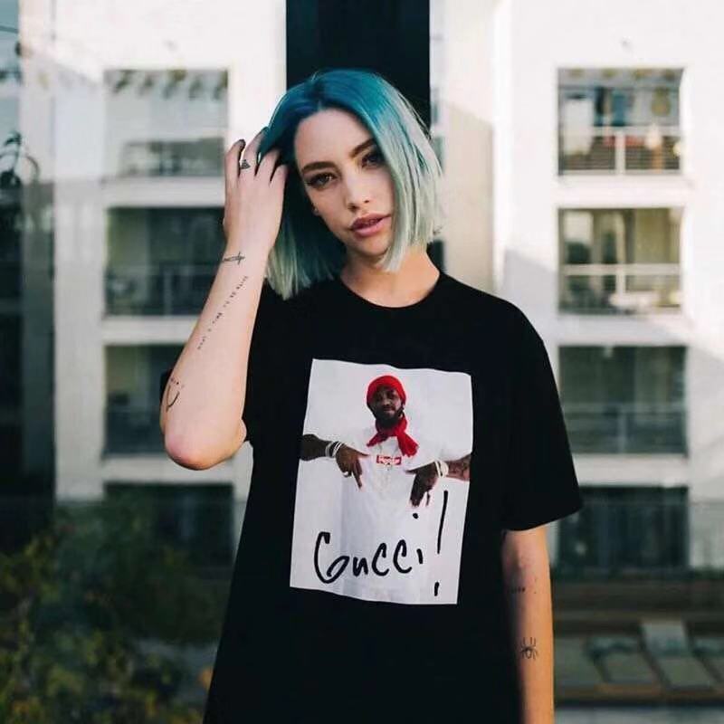 Stussy black T-shirt worn by model with front 'Gucci' portrait graphic