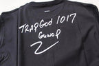 Stussy black T-shirt back close-up: 'Trap God 1017' and 'GunvoP' text