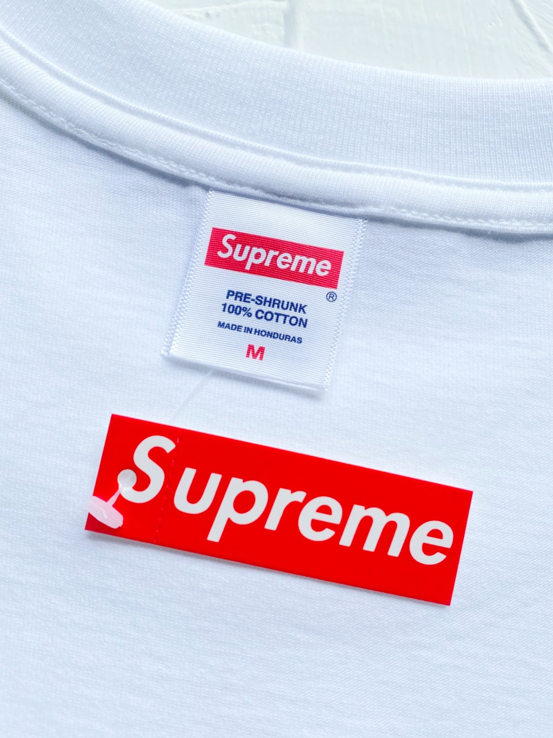 White T-shirt neck label and Supreme logo patch