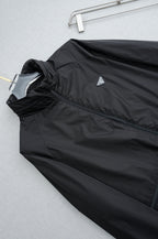 Prada long jacket front panel with diagonal logo patch and dark fabric texture
