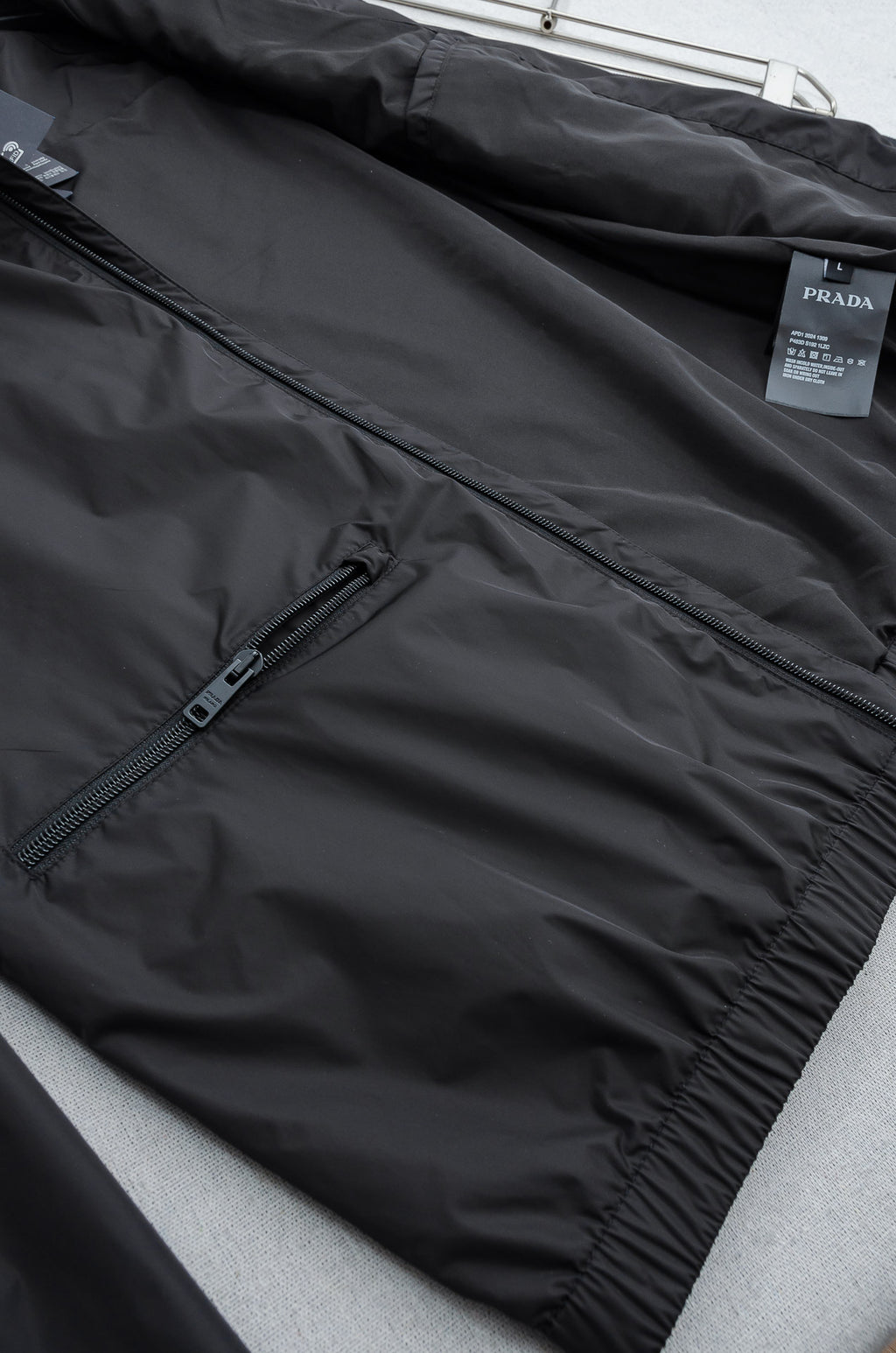 Prada long jacket with front zipper and snap-button lower hem