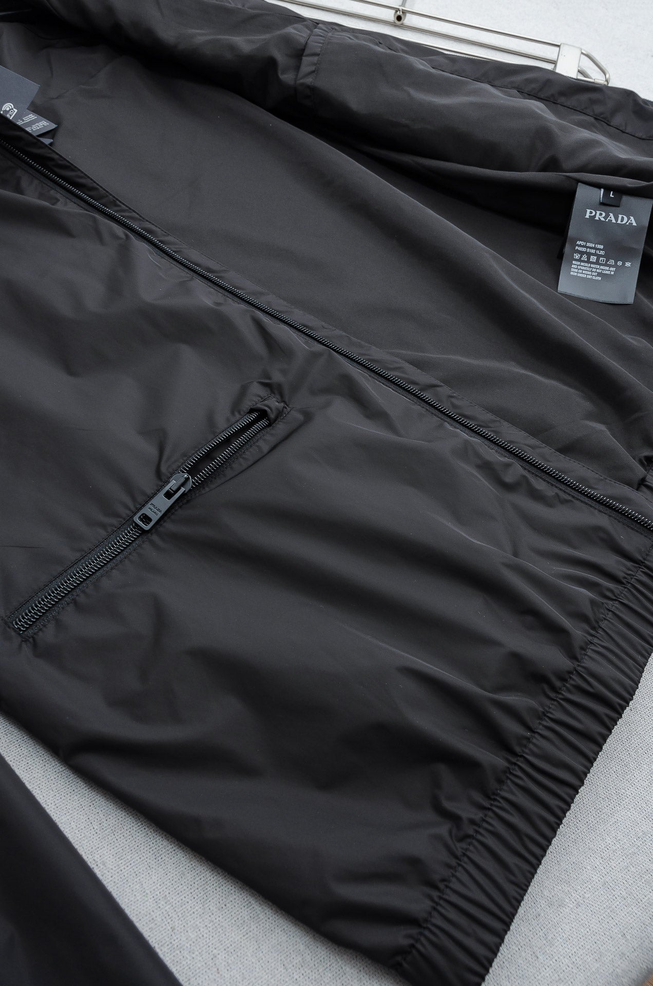 Prada long jacket with front zipper and snap-button lower hem