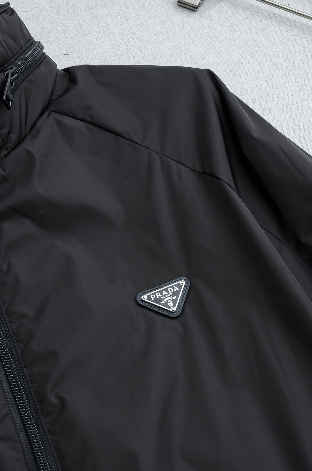 Prada long jacket sleeve with embroidered Prada triangle logo badge