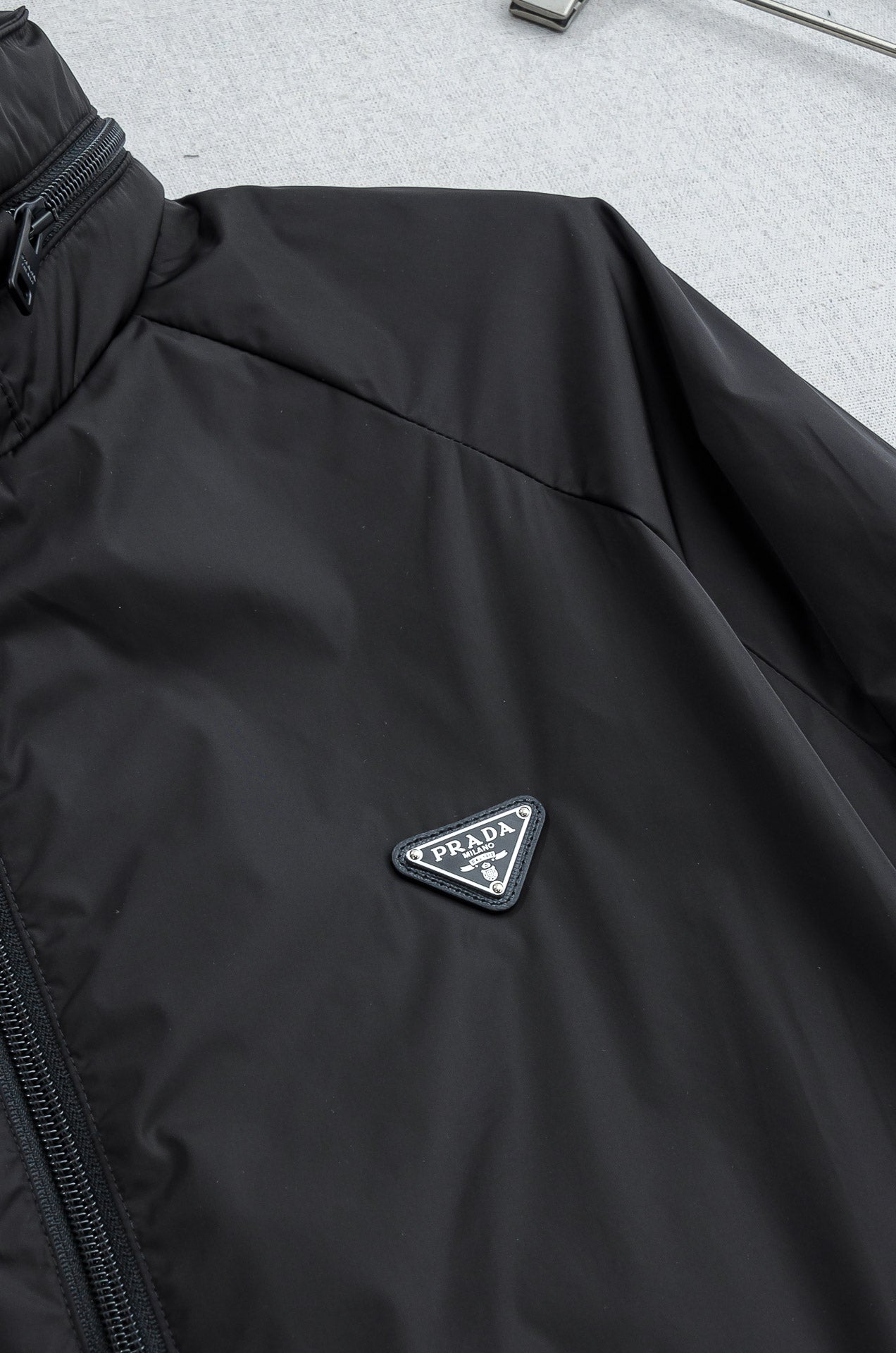 Prada long jacket sleeve with embroidered Prada triangle logo badge