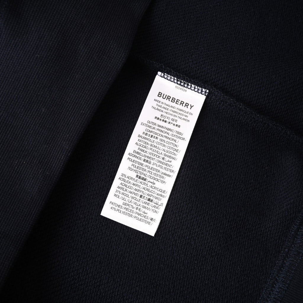 Dark navy sweatshirt fabric close-up with white interior care and size label