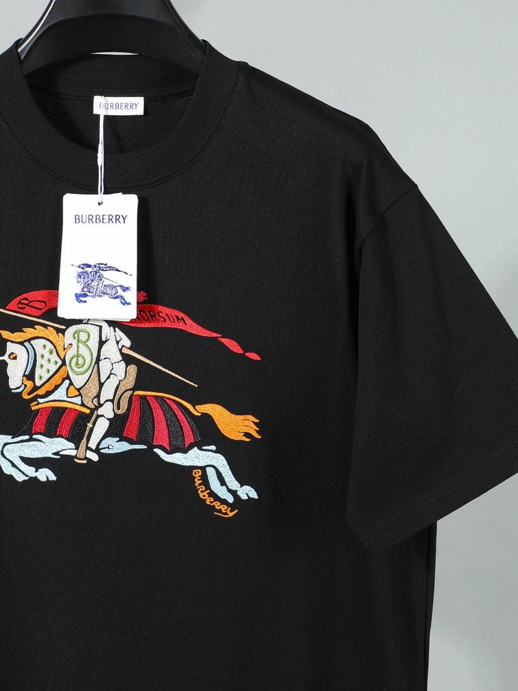 Black T-shirt with large horse-and-rider print on front.