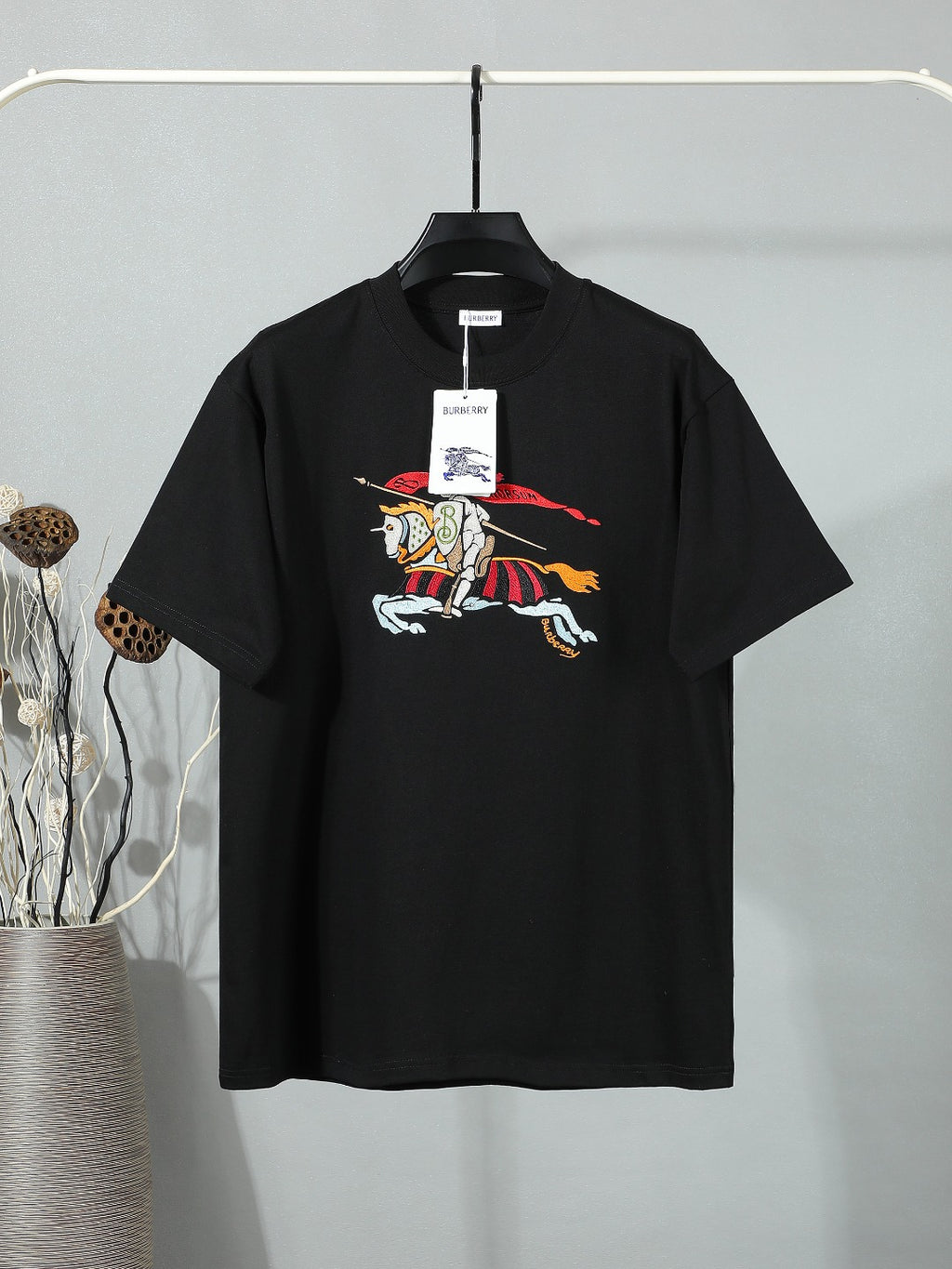 Black short-sleeve T-shirt with colorful horse-and-rider graphic at chest.