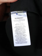 Black T-shirt inner care label with size and fabric composition text.