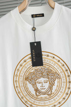 Versace white T-shirt close-up of gold Medusa circular graphic and round neckline