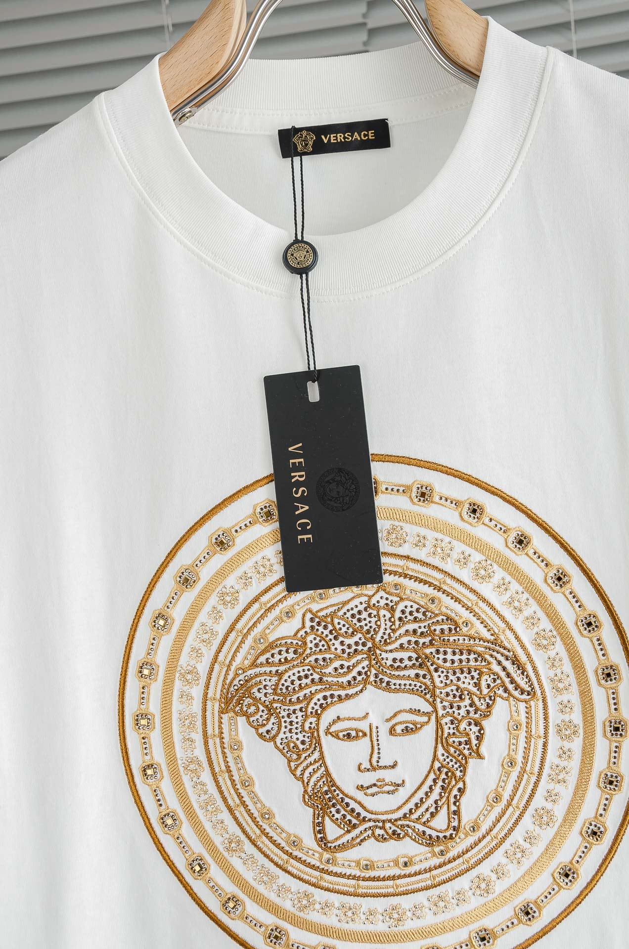 White crew-neck T-shirt with gold Medusa medallion print