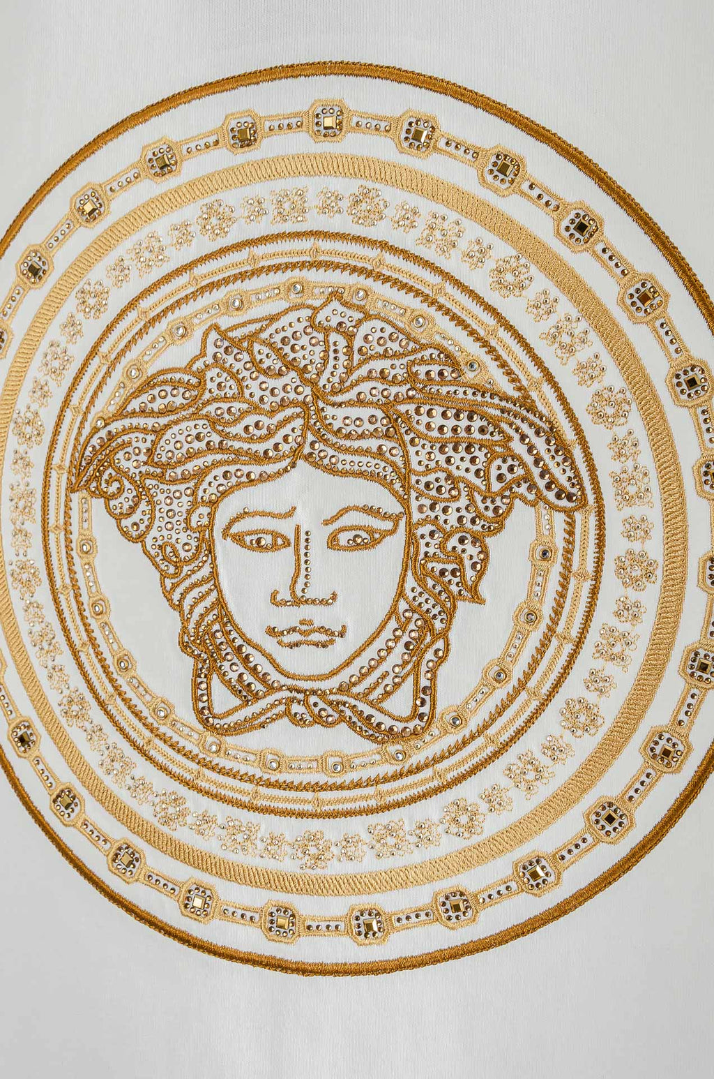 Versace T-shirt chest graphic close-up with gold Medusa face medallion details