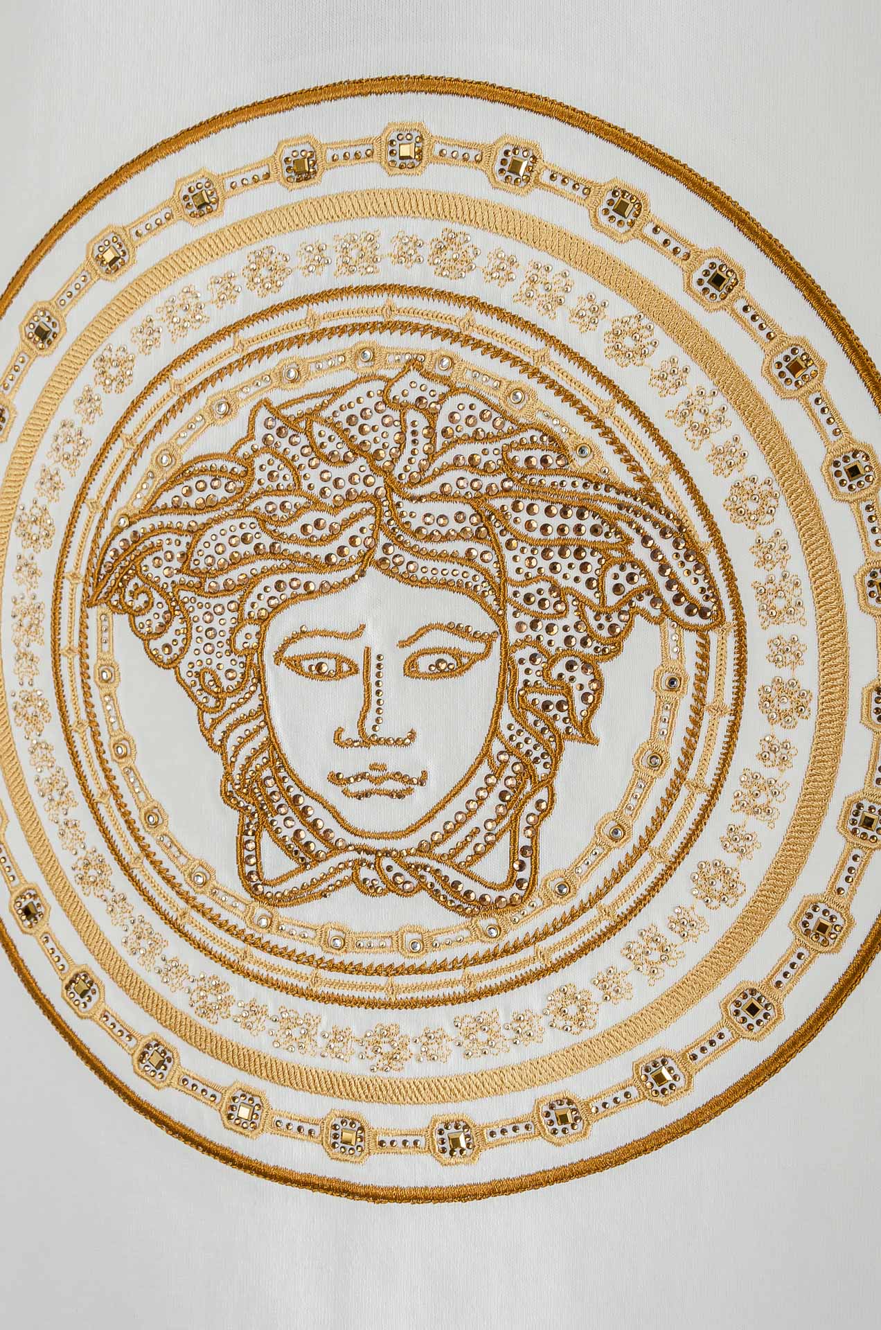 Versace T-shirt chest graphic close-up with gold Medusa face medallion details