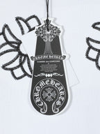 White T-shirt chest logo tag detail with black embroidered crest graphic