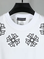 White short-sleeve T-shirt close-up of black flower embroidery around neckline