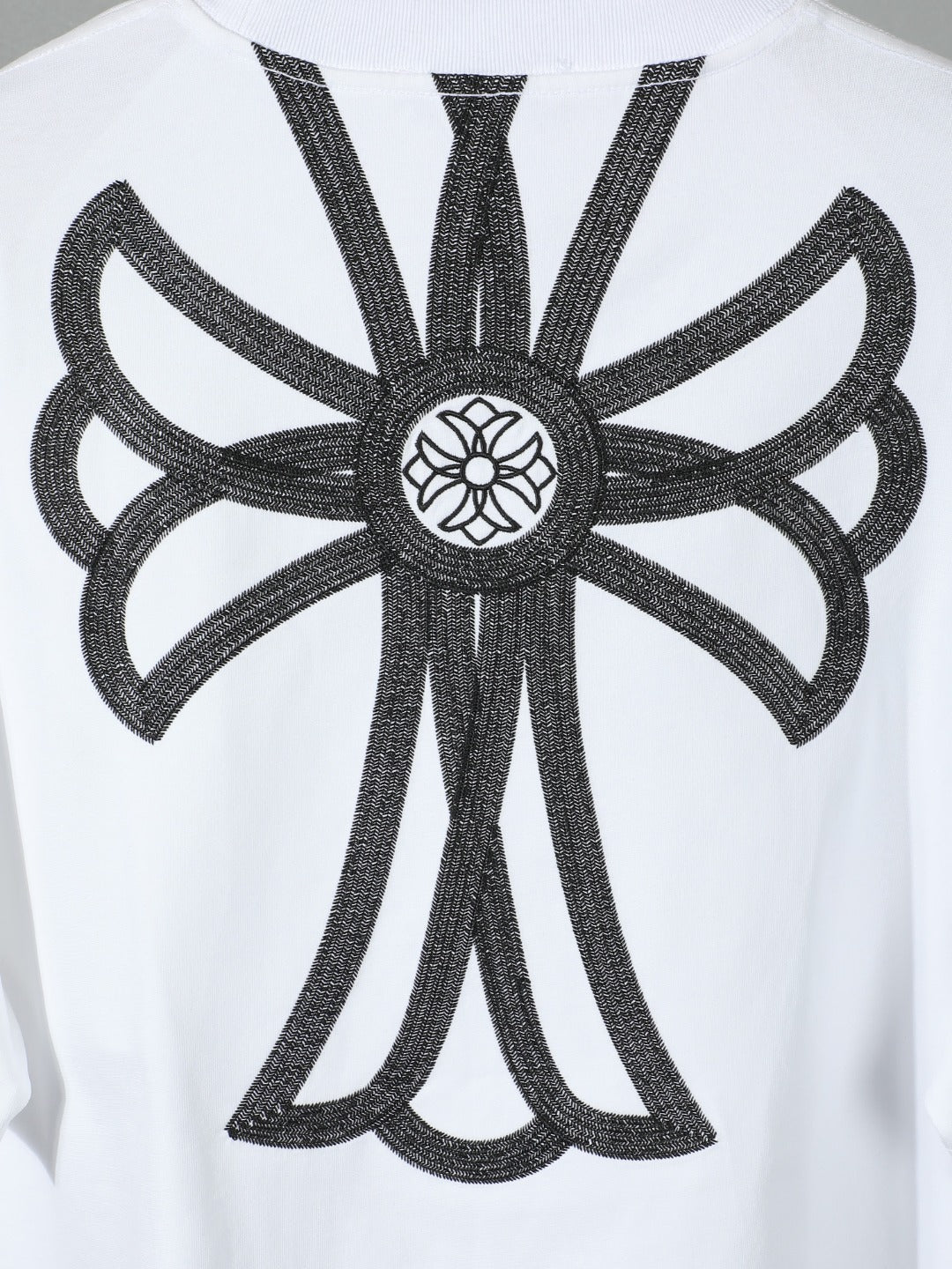 White T-shirt close-up of large black back angel embroidery design