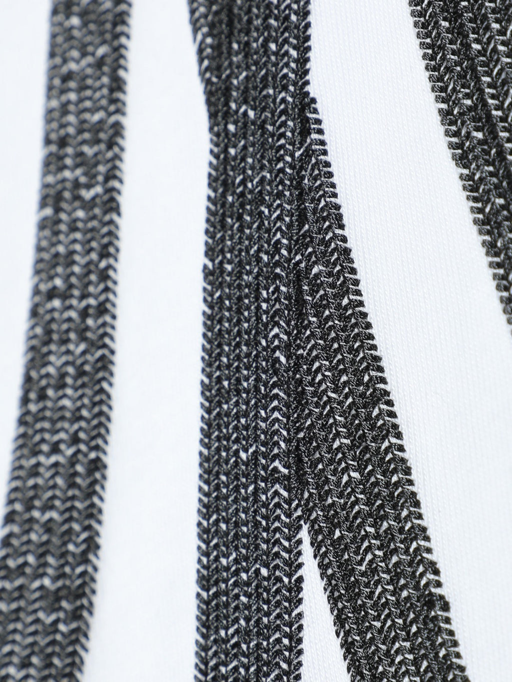 White T-shirt embroidery close-up showing textured black stitch lines and rays