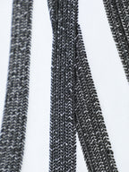 White T-shirt embroidery close-up showing textured black stitch lines and rays