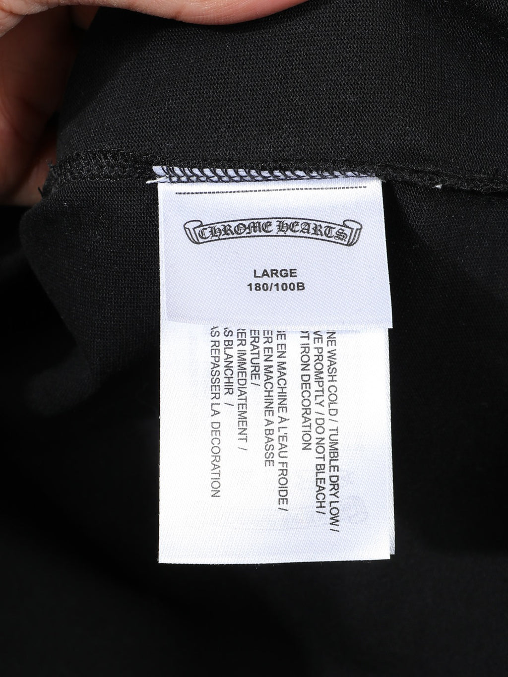 Large size label inside dark shorts with care instructions