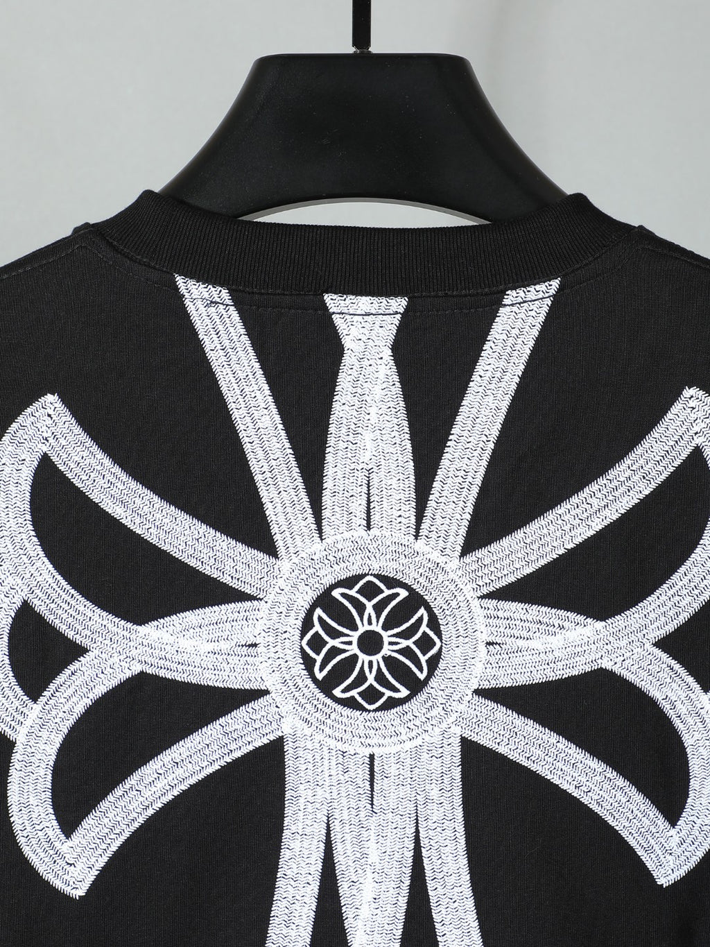Black short-sleeve T-shirt with large white backburst graphic centered on top