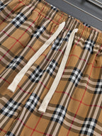 Plaid shorts fabric close-up with elastic waist and white drawstring