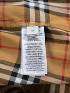 Inside care label on plaid shorts waistband, cotton and elastane blend