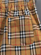 Plaid patch pocket on front of shorts, tan and black check